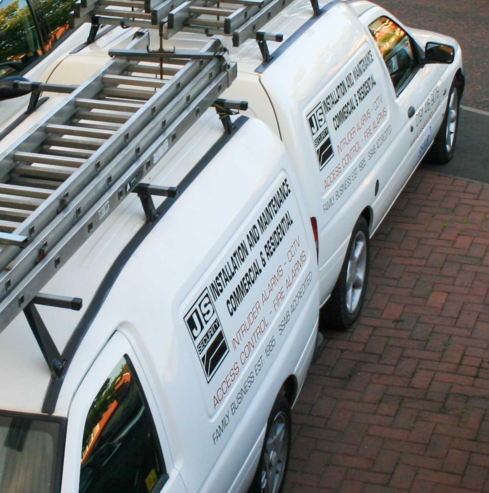 The original JS Security family-business vans — AMP's roots, a North East family business established 1985